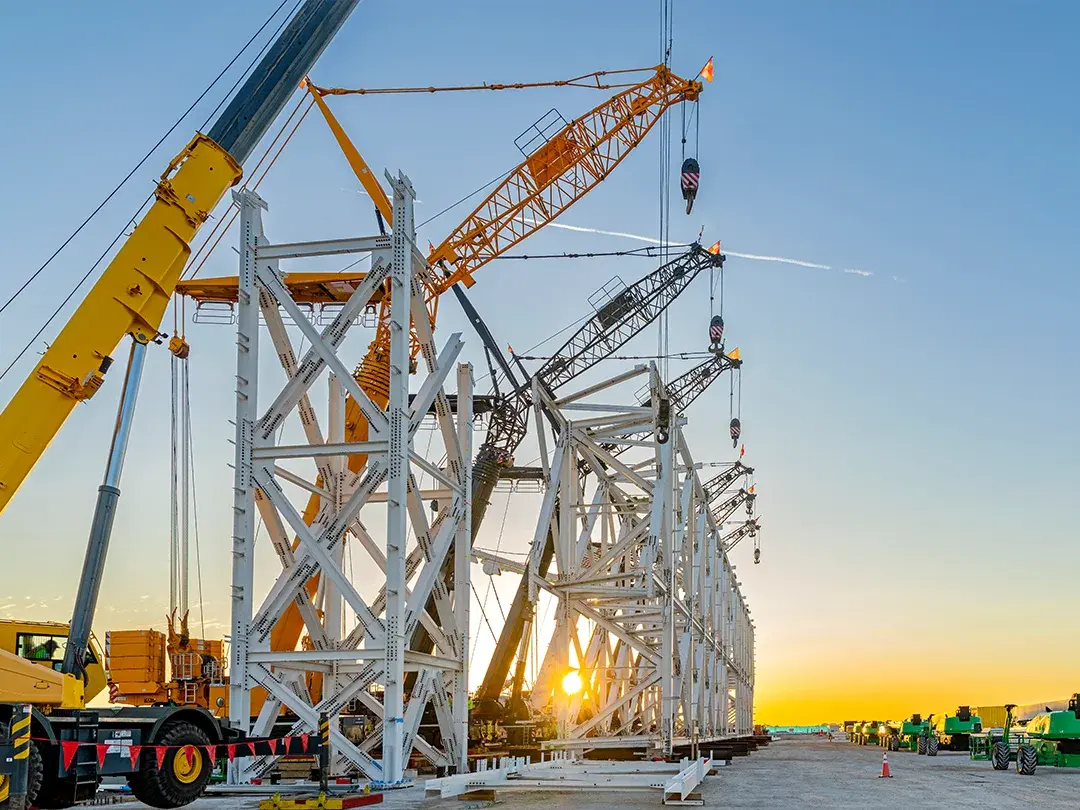 image of construction site lift of large truss structure by multiple cranes