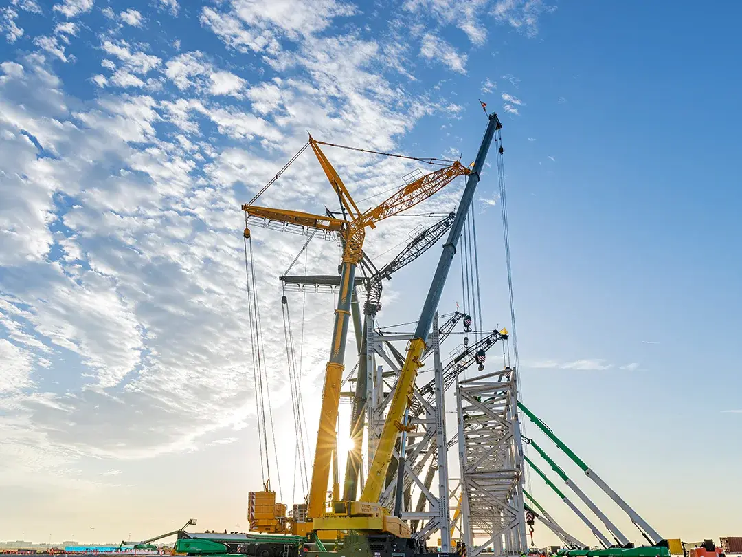 image of construction site lift of large truss structure by multiple cranes