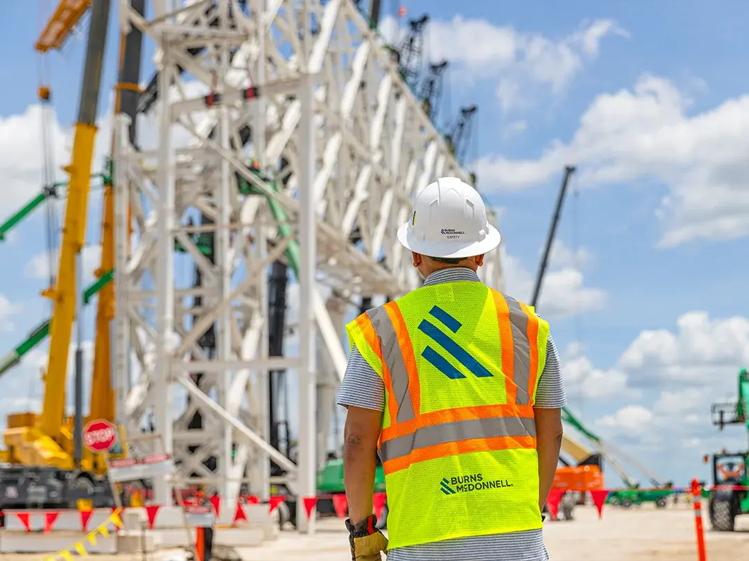 image of construction site lift of large truss structure by multiple cranes
