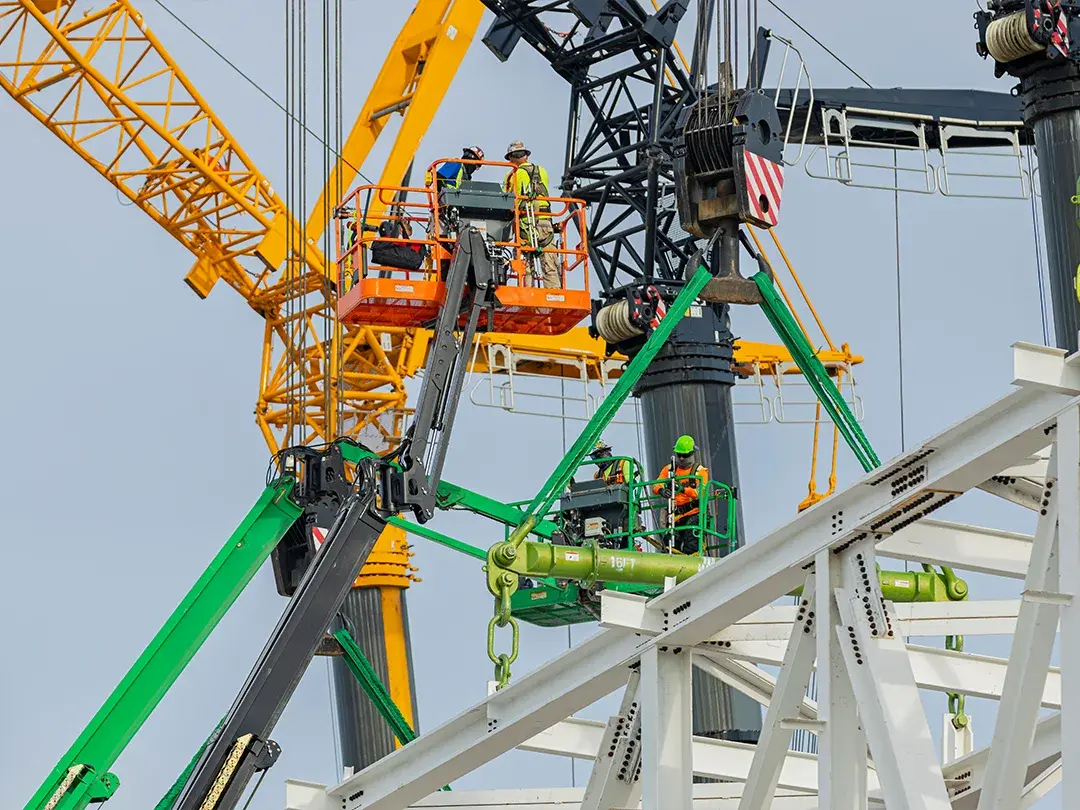 image of construction site lift of large truss structure by multiple cranes